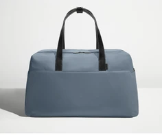 Front view of Away's Weekender duffle in Coast Blue with handles up