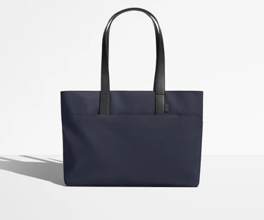 Front view of The Everywhere Tote with its leather handles up
