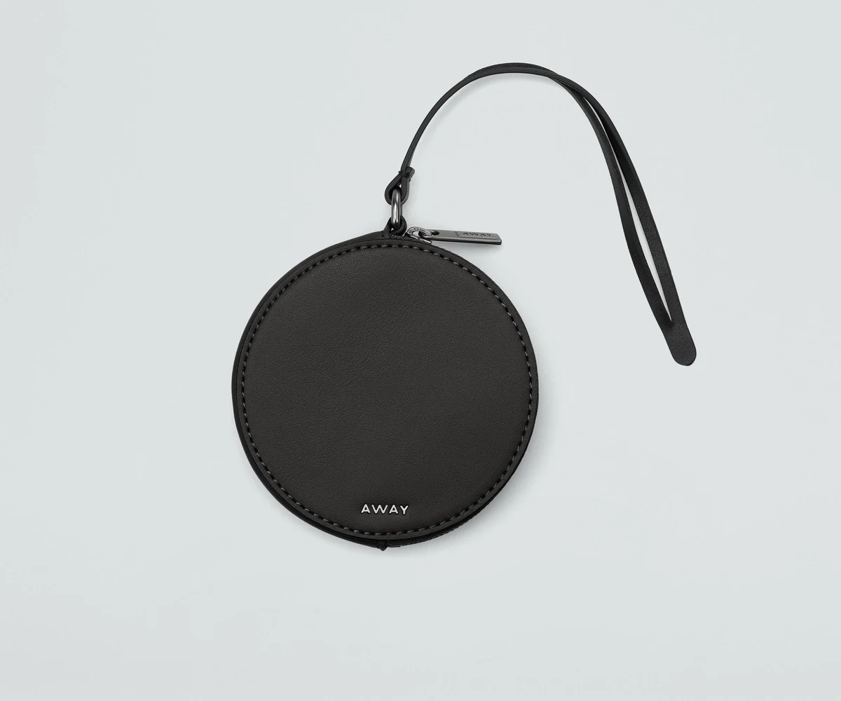 Front view of the Circle Zip Pouch with the leather strap