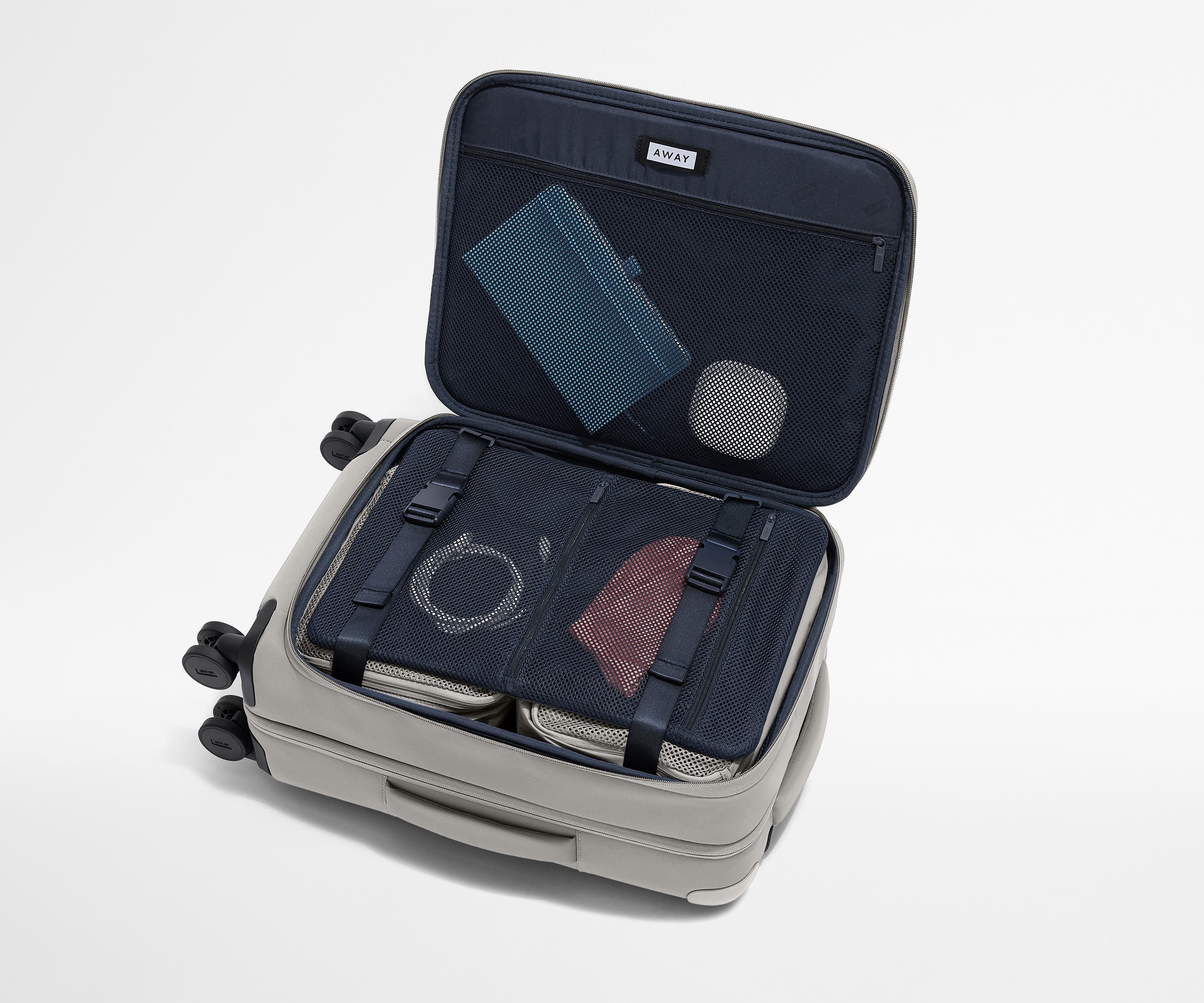 Open Softside suitcase, with travel essentials in the front flap pocket and compression pad pockets