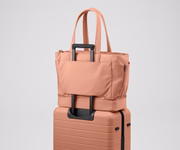 Double Diaper Tote on top of an Away suitcase by the trolley sleeve