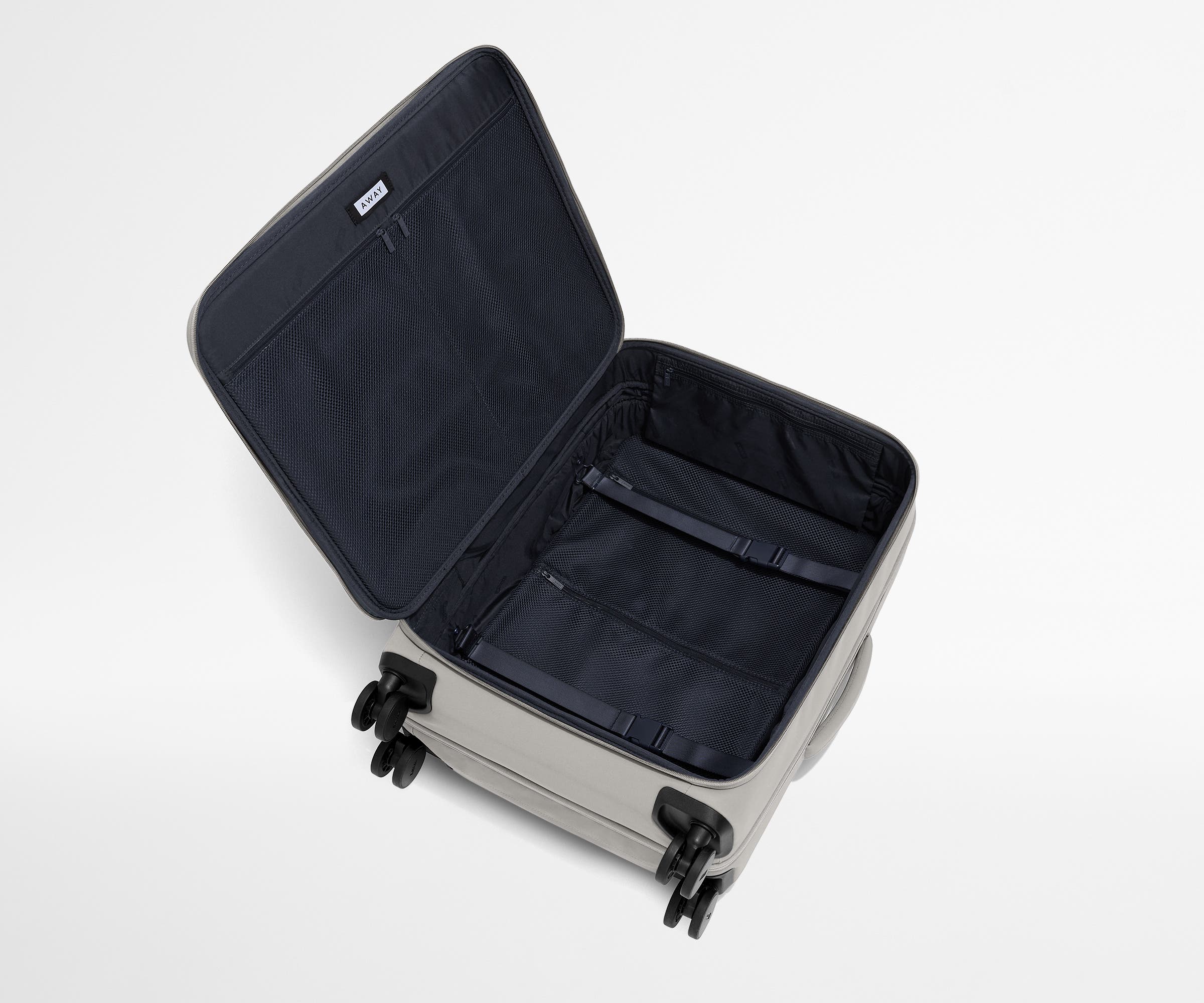 Open, unpacked Softside Medium suitcase, showing the depth of the bag and signature compression pad feature