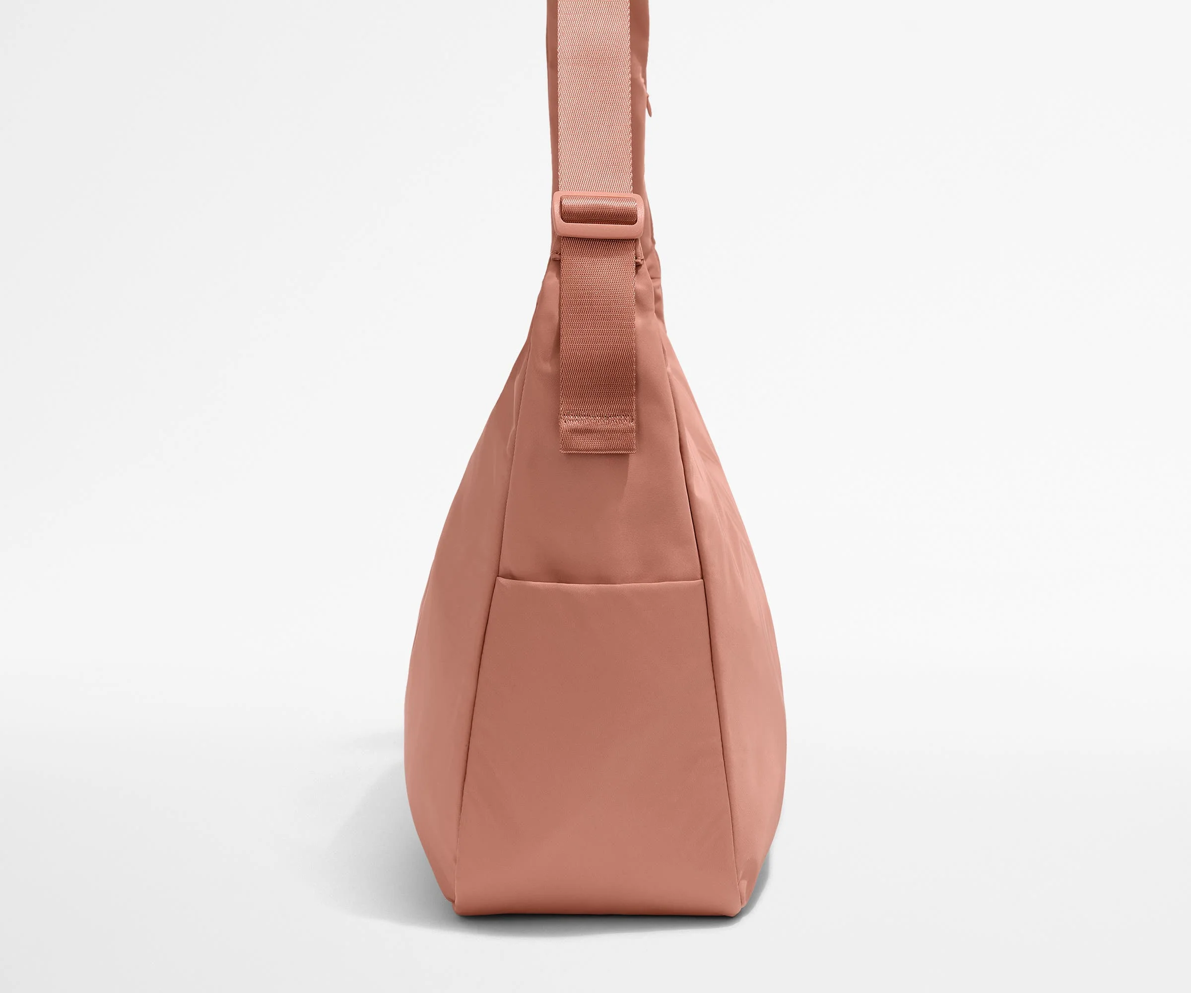 Side view of the Large Featherlight Crossbody showing the exterior bottle pocket