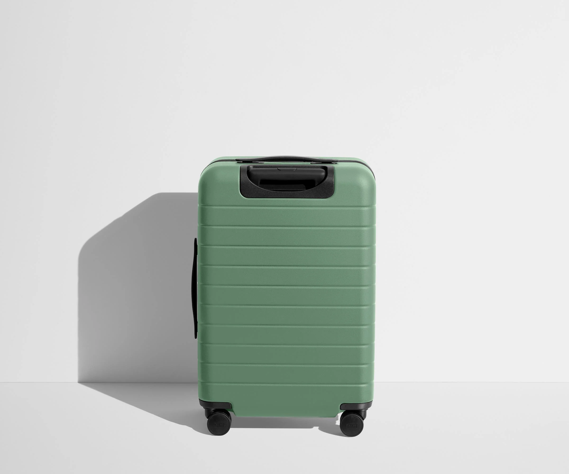Back product view of The Bigger Carry-On suitcase in Sea Green