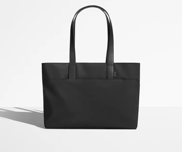 Front view of The Everywhere Tote with its leather handles up