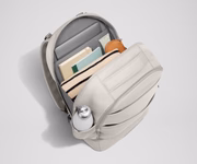 Back main compartment packed with adult travel essentials, including a laptop, notebook, and extra clothes