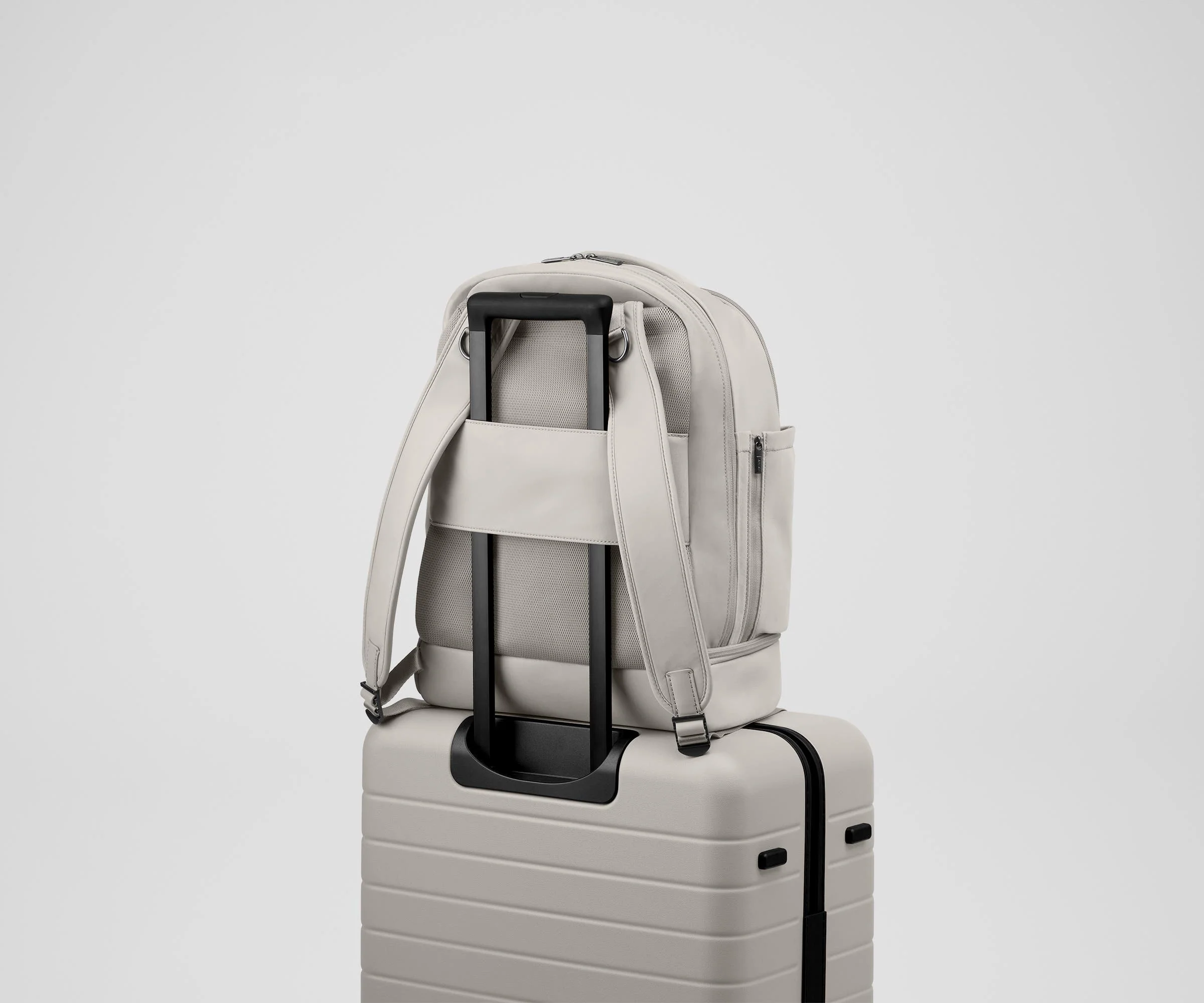 Double Diaper Backpack on top of an Away suitcase by the trolley sleeve