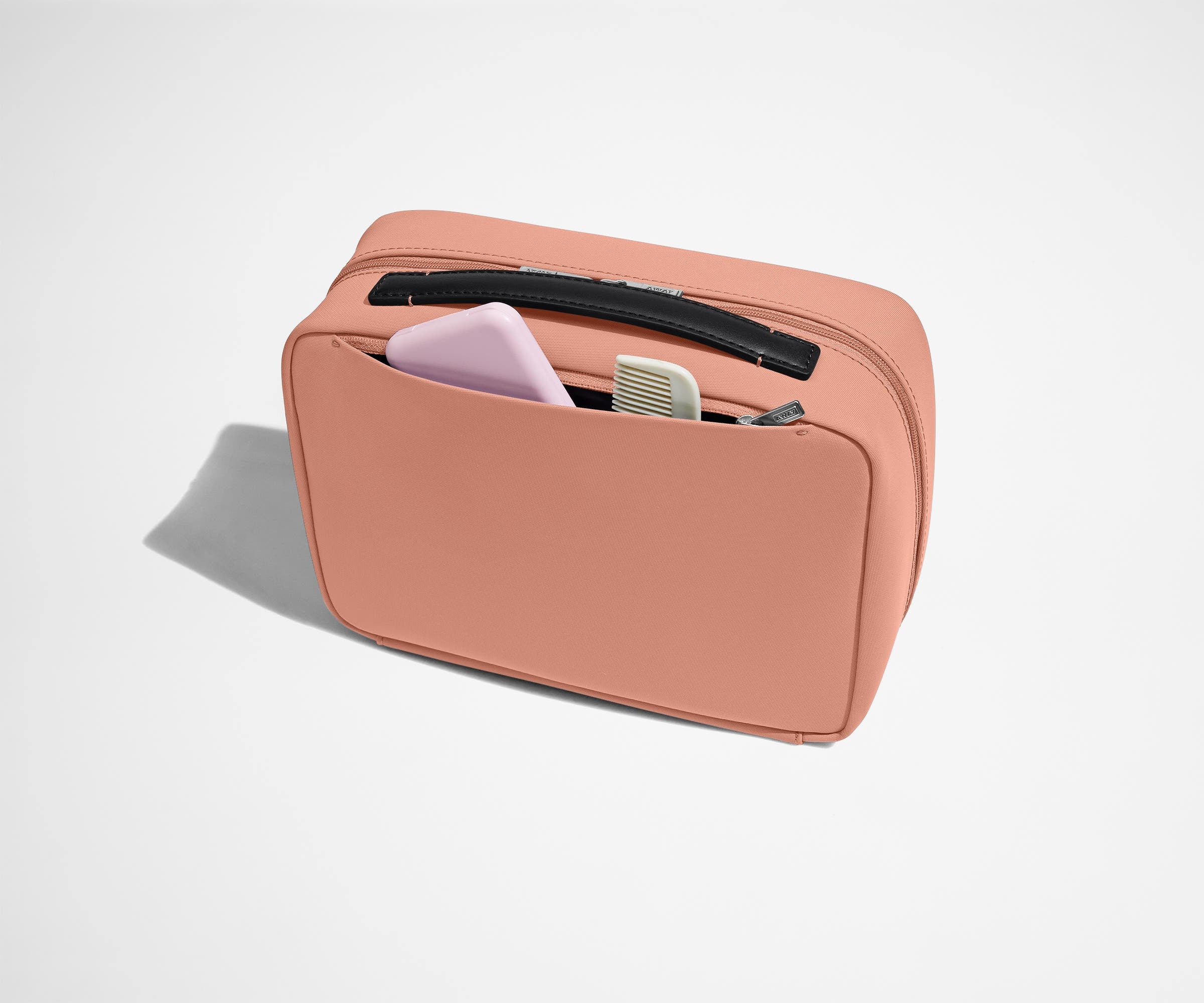 Exterior zip pocket packed with a comb and other toiletries