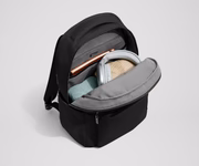 Main compartment of the Commuter Backpack packed with a notebook, light layers, and headphones