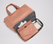 Bottom compartment shown with the included changing pad and Carry-All pouch that fits diapers and wipes