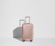 Front view of a Bigger Carry-On: Aluminum Edition suitcase with handles raised