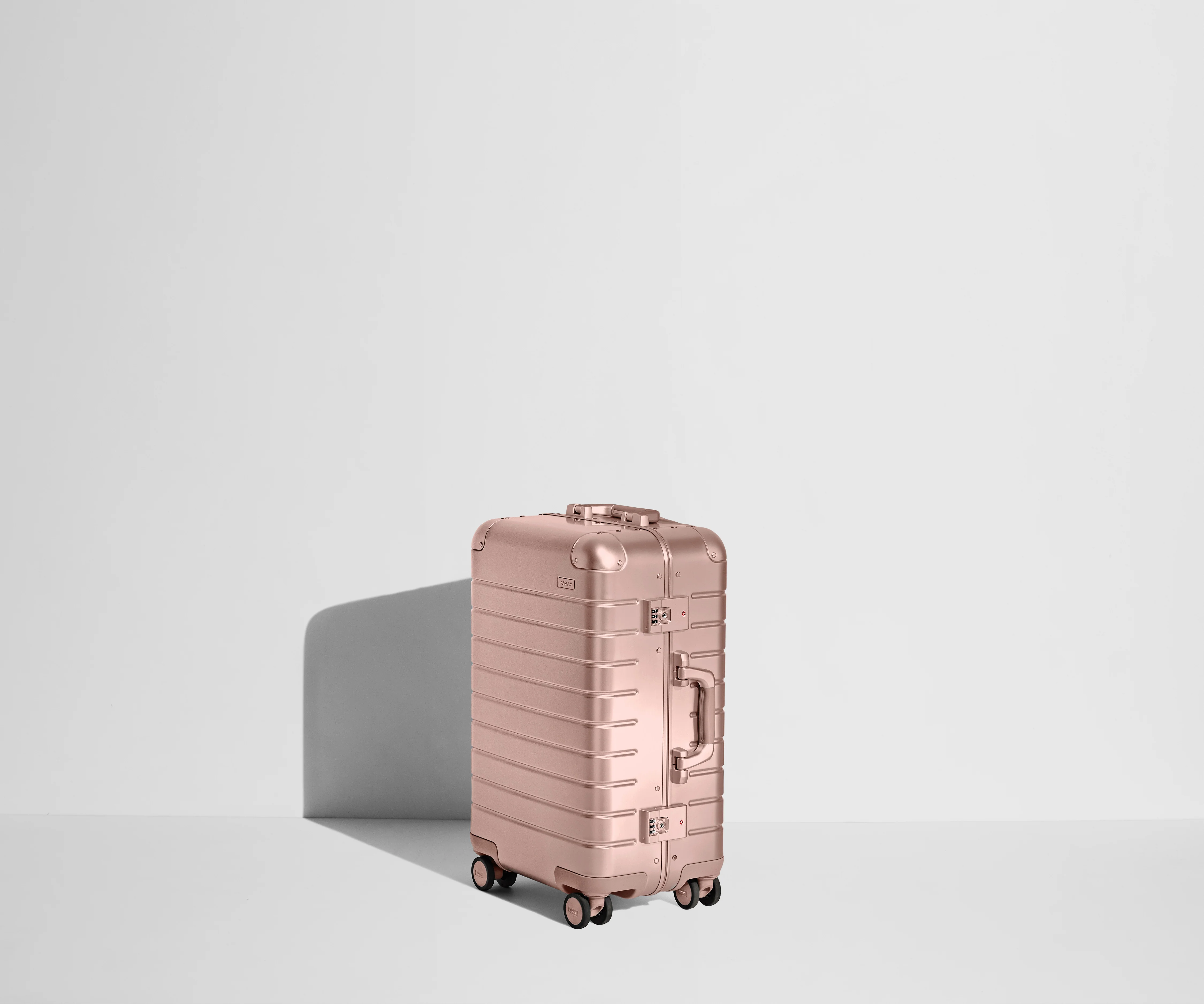 Angled view of the Rose Gold Bigger Carry-On Aluminum suitcase