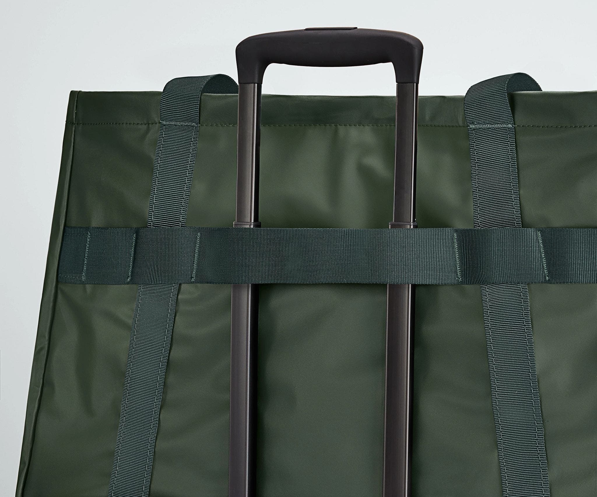 Active Tote 45L secured to an Away suitcase by its trolley strap