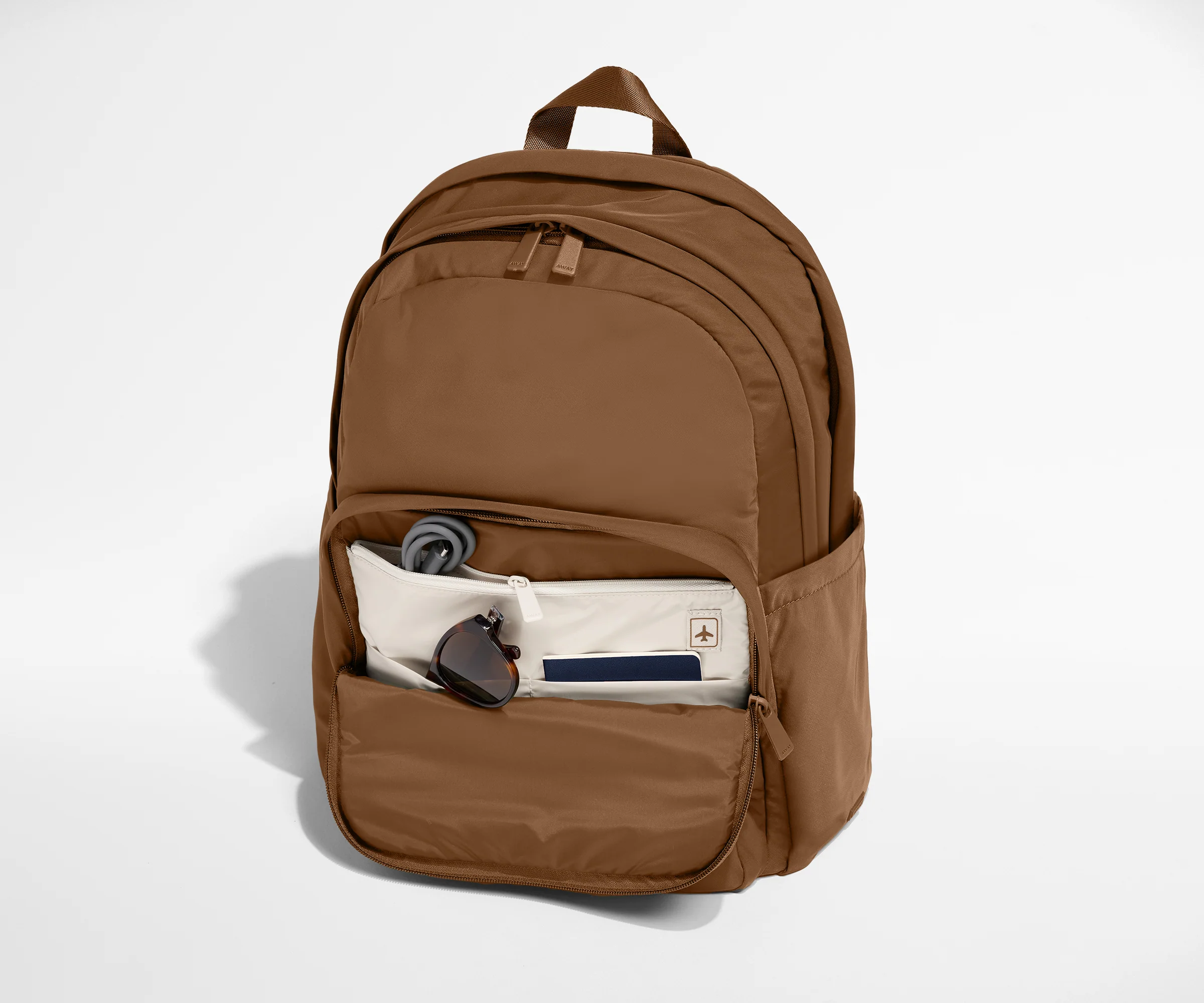Phone, passport, and keys in their dedicated pockets in the front zip pocket