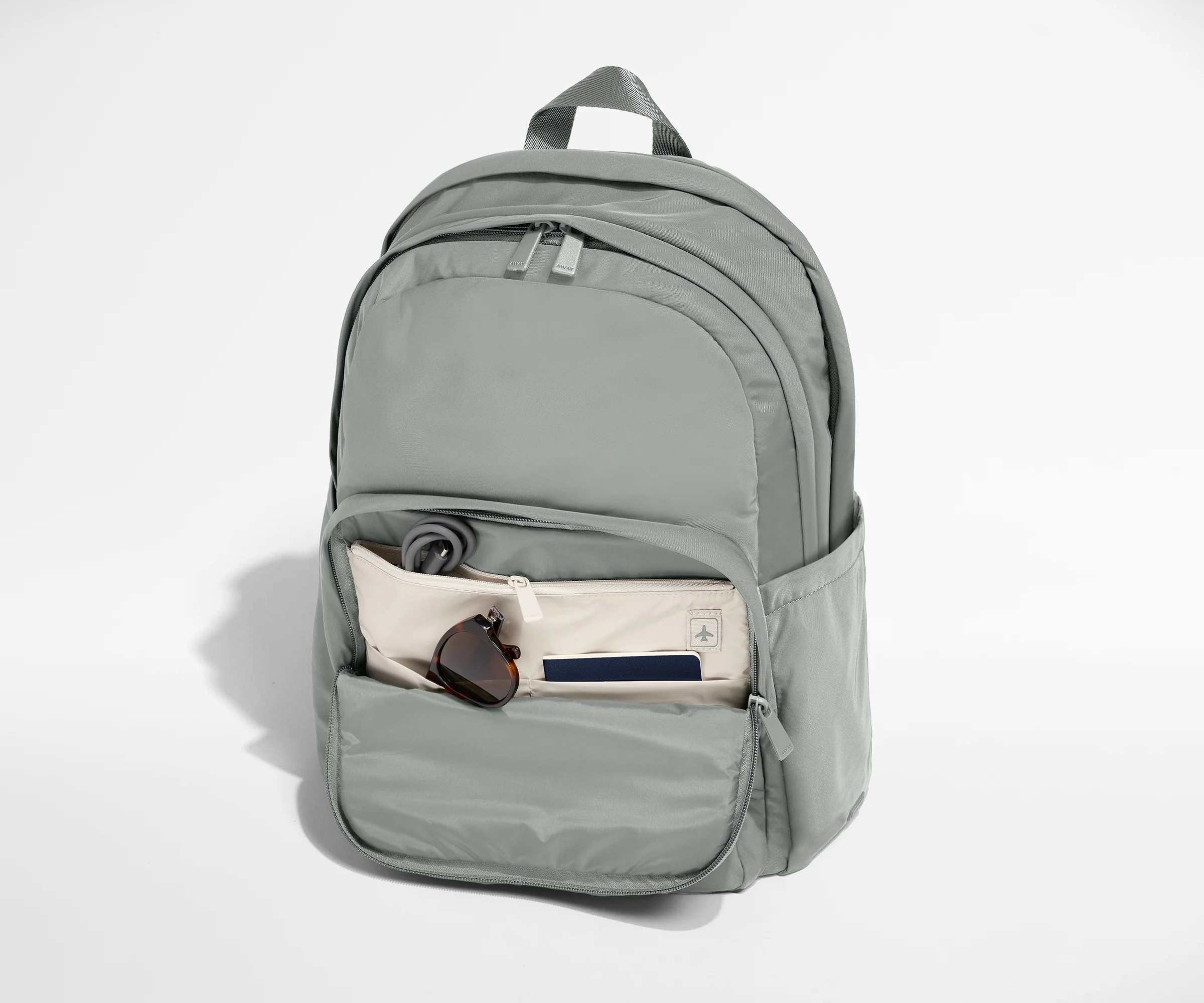 Gray backpack with front pocket on a white background