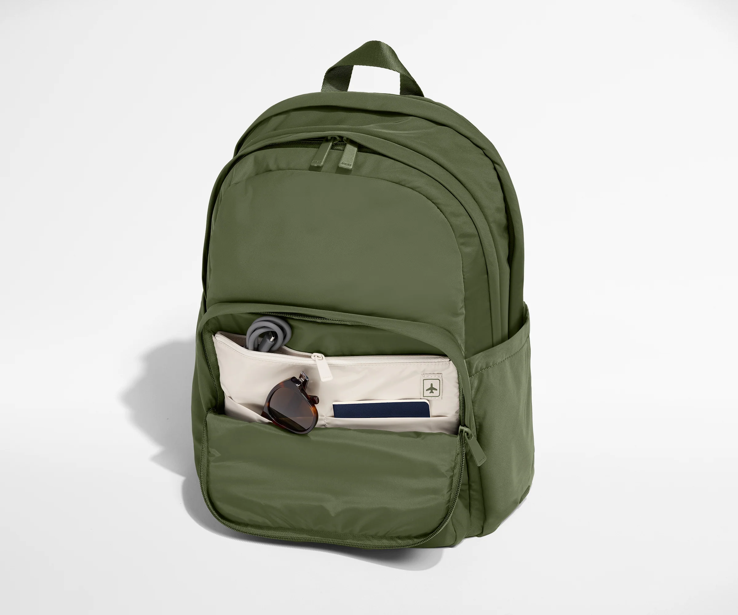 Green backpack with front pocket on a white background