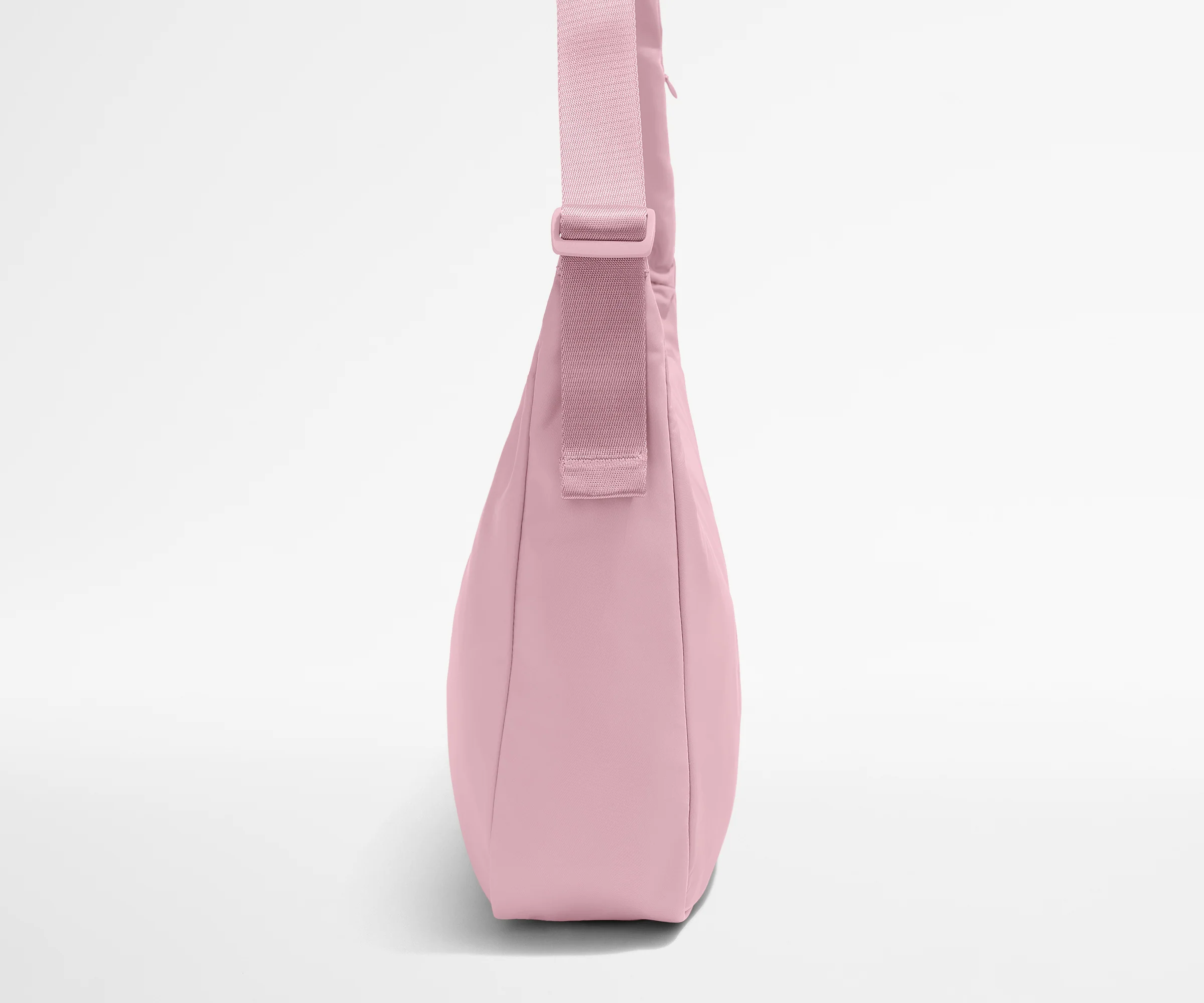 Pink crossbody bag on a light gray background