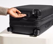 The Carry-On Flex suitcase in Jet Black shown from below highlighting the underside grab handle