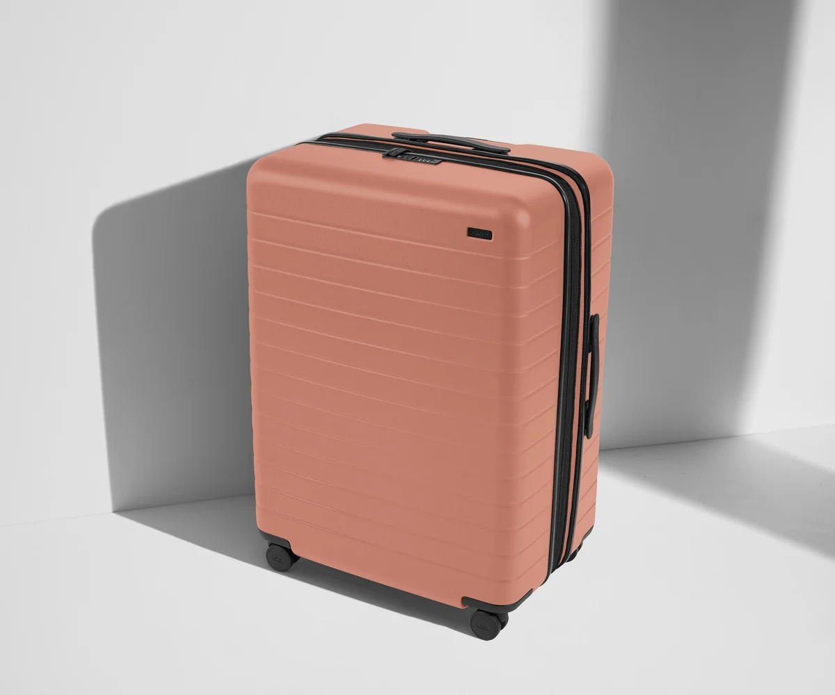 Angled product view of The Large Flex suitcase in Clay Pink
