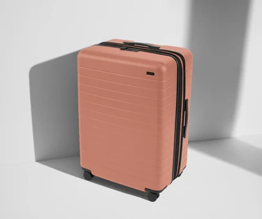 Angled product view of The Large Flex suitcase in Clay Pink