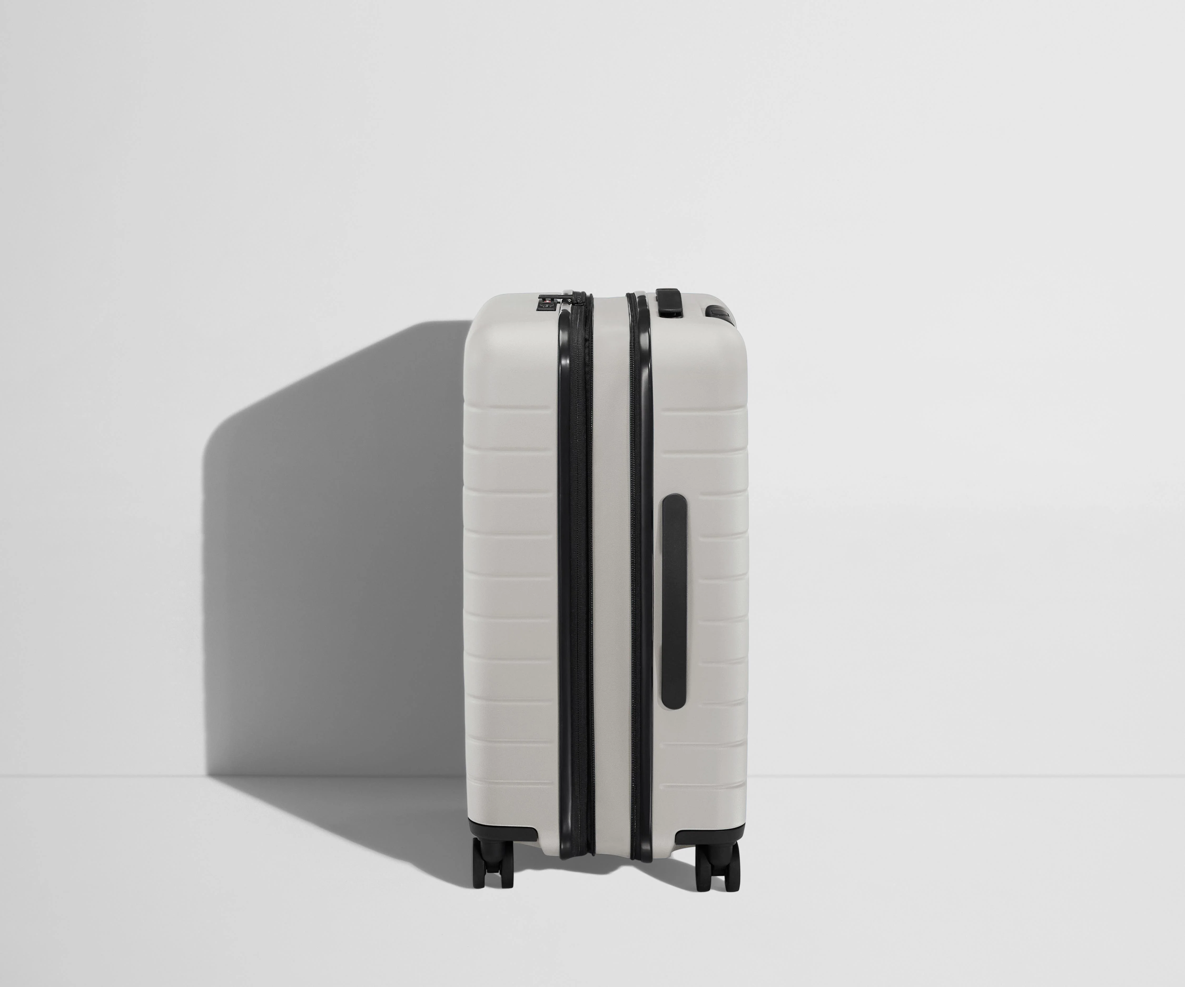 Side product view of The Bigger Carry-On Flex suitcase in Cloud Gray shown fully expanded