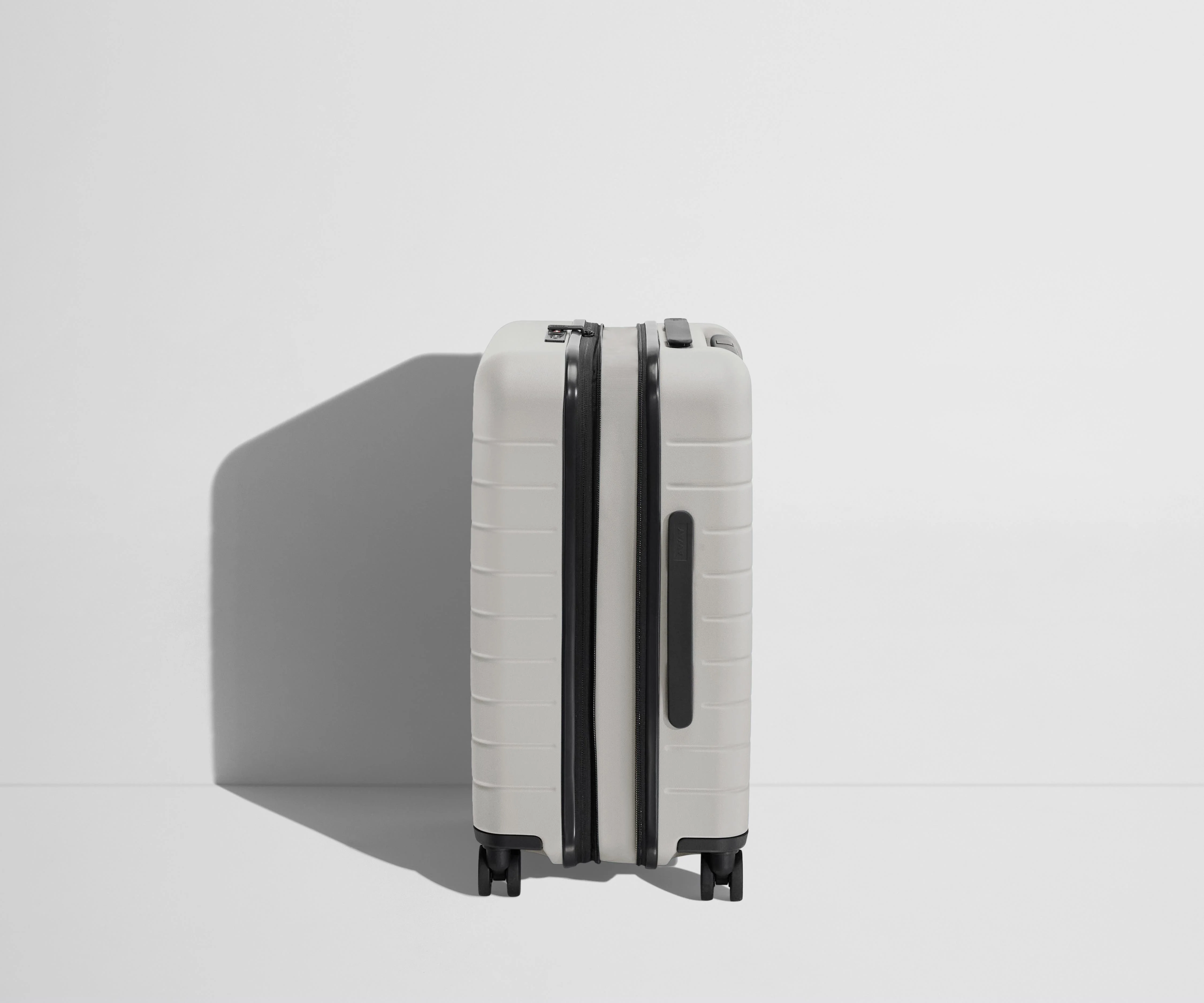 Side product view of The Carry-On Flex suitcase in Cloud Gray shown fully expanded