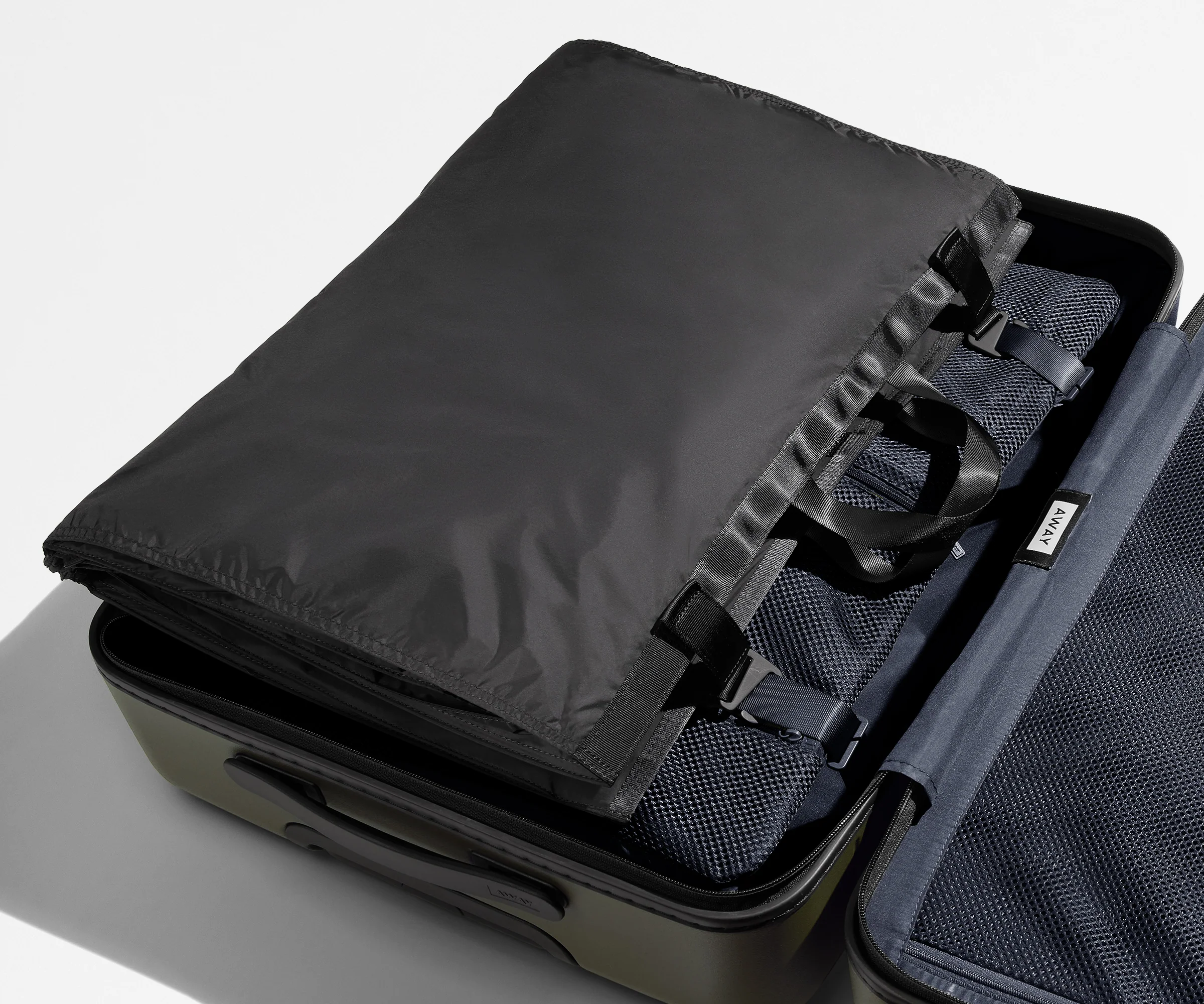 Folded Garment Sleeve clipped inside a checked suitcase