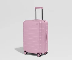 Pink suitcase on a light gray background