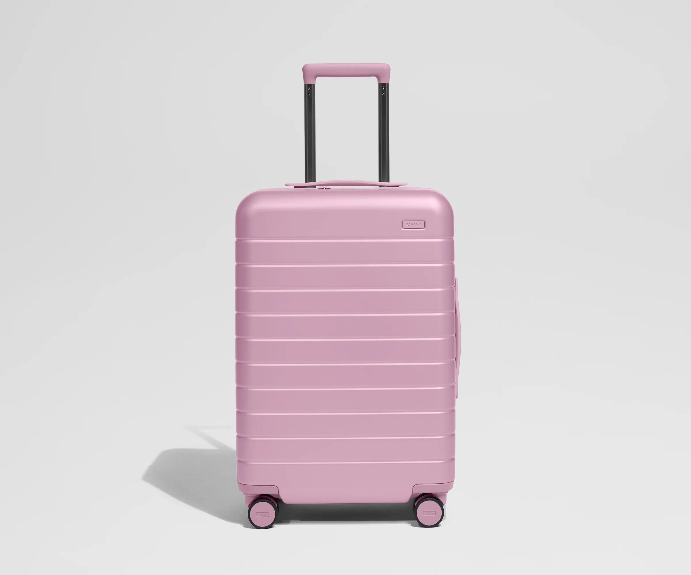 Pink suitcase on a light gray background