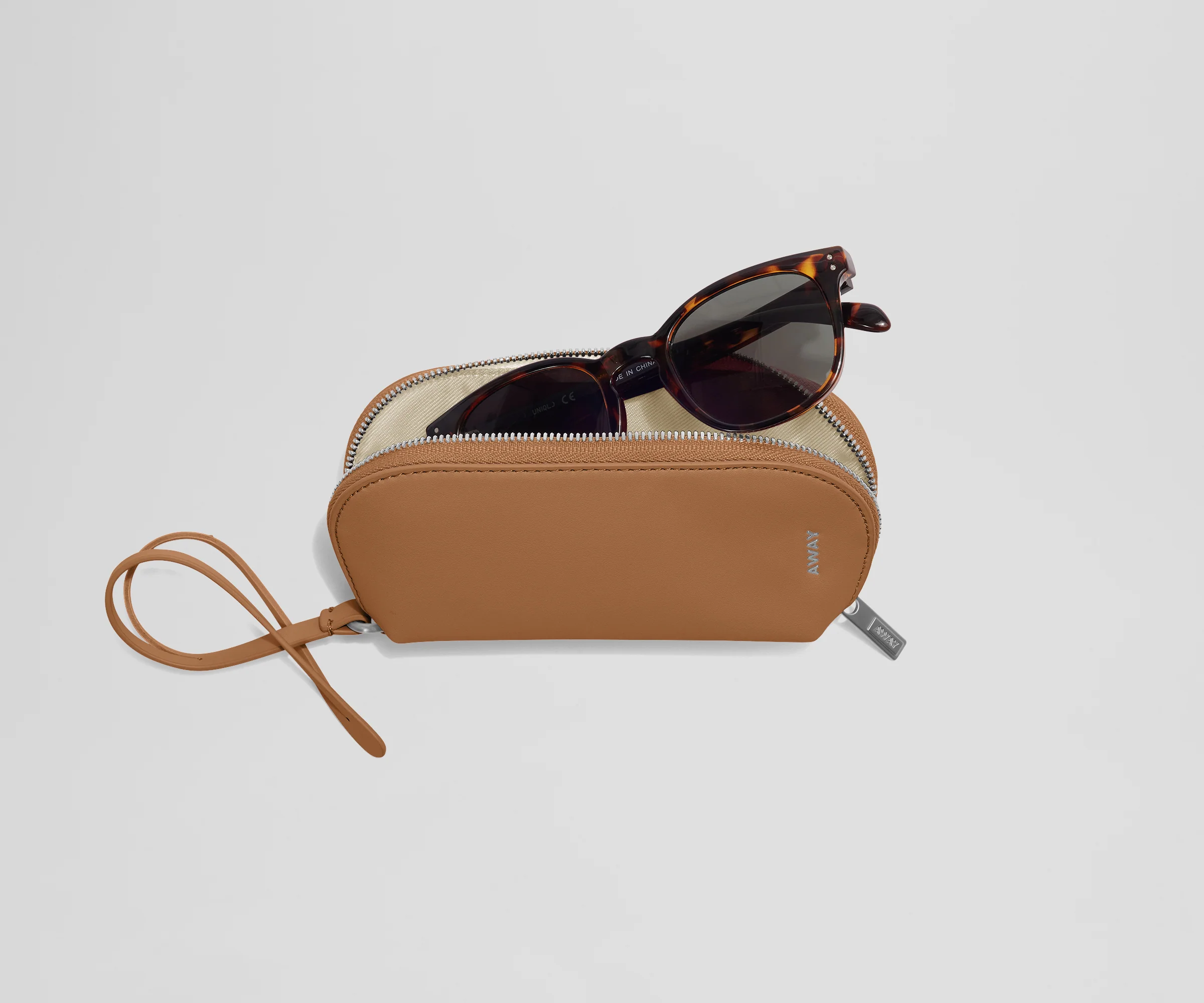 A pair of sunglasses inside an open Sunglasses Pouch