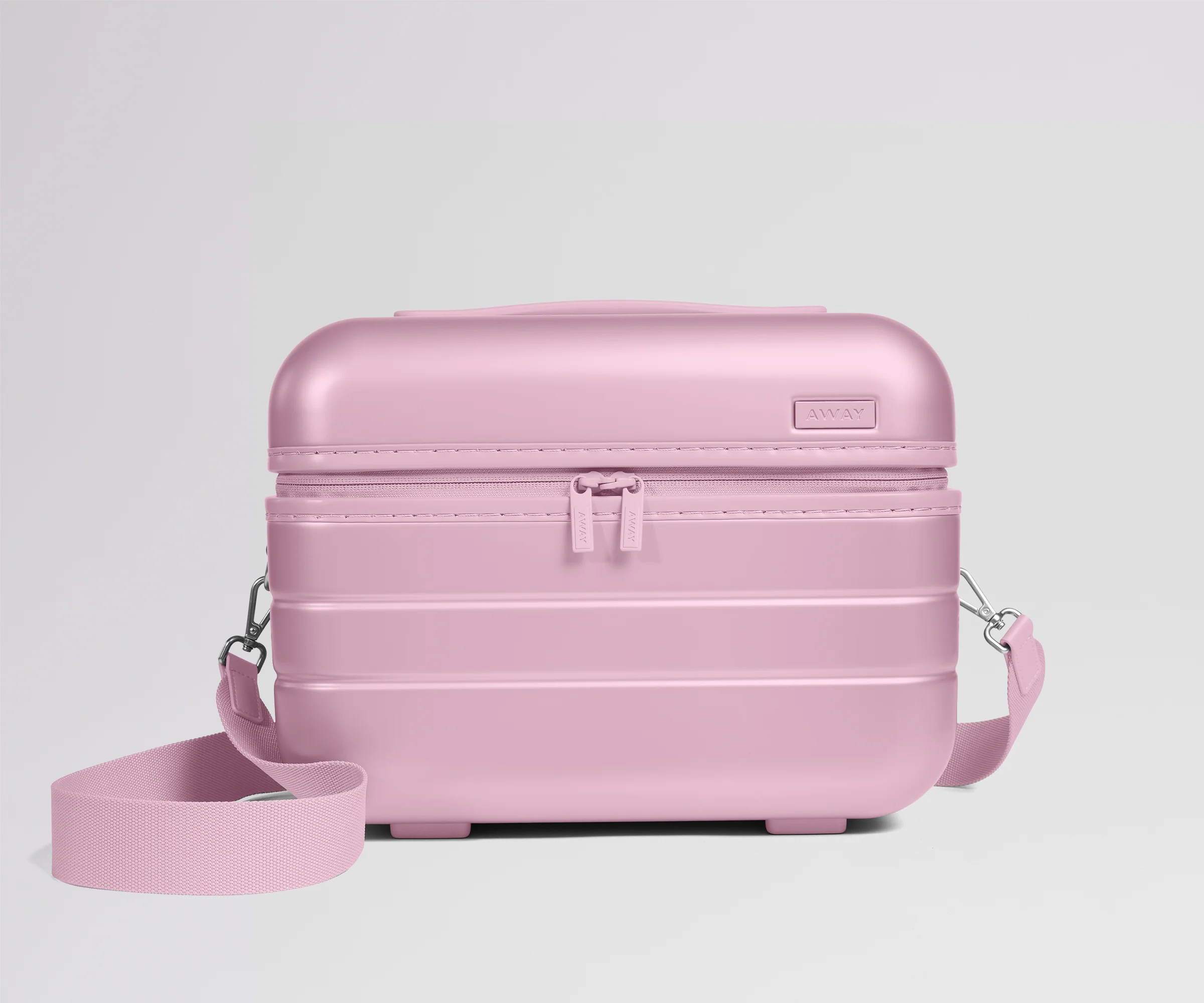 Pink travel case with a strap on a light gray background