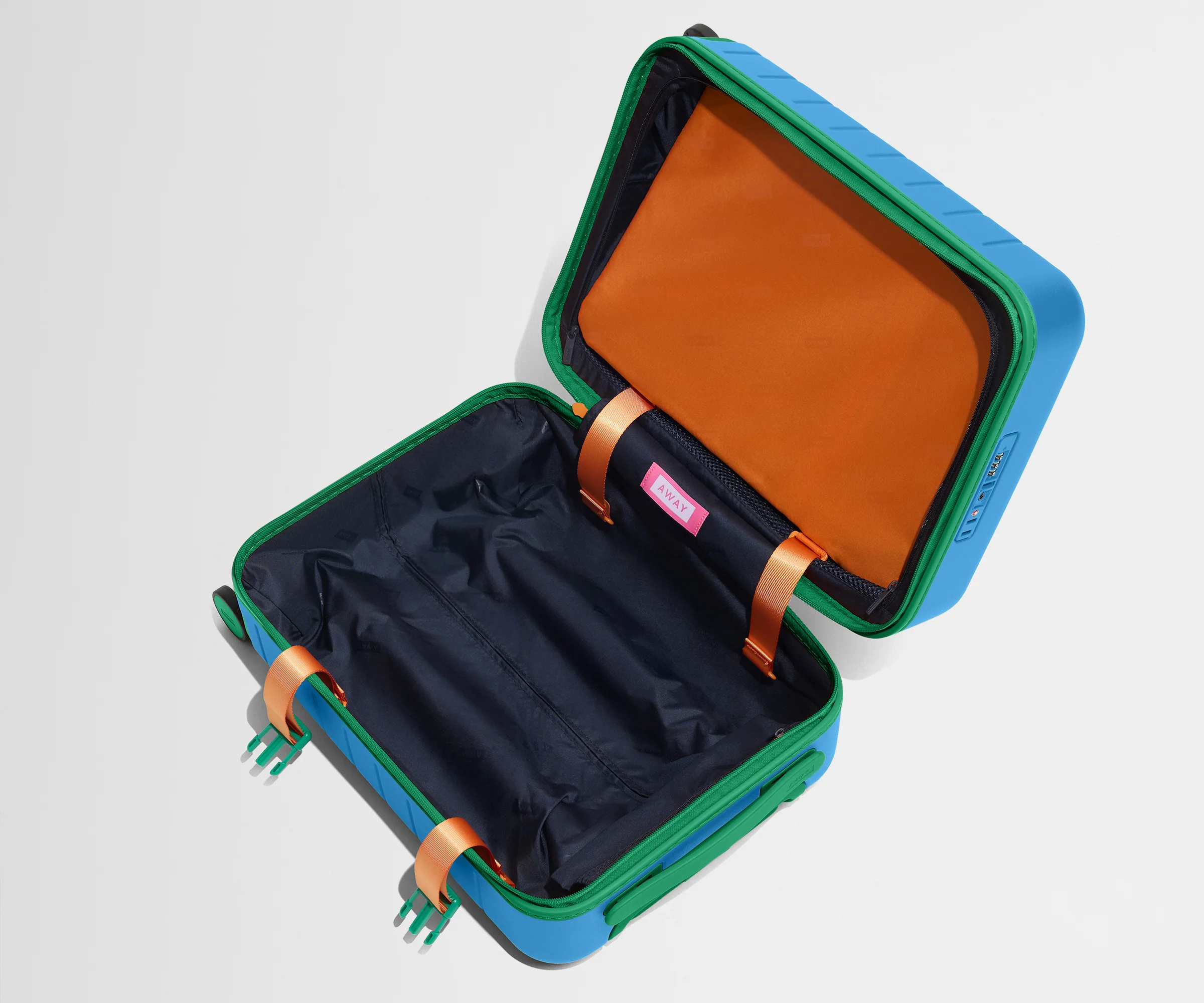 The Kids Carry-On suitcase in Splash Blue shown open and empty on its side to show capacity