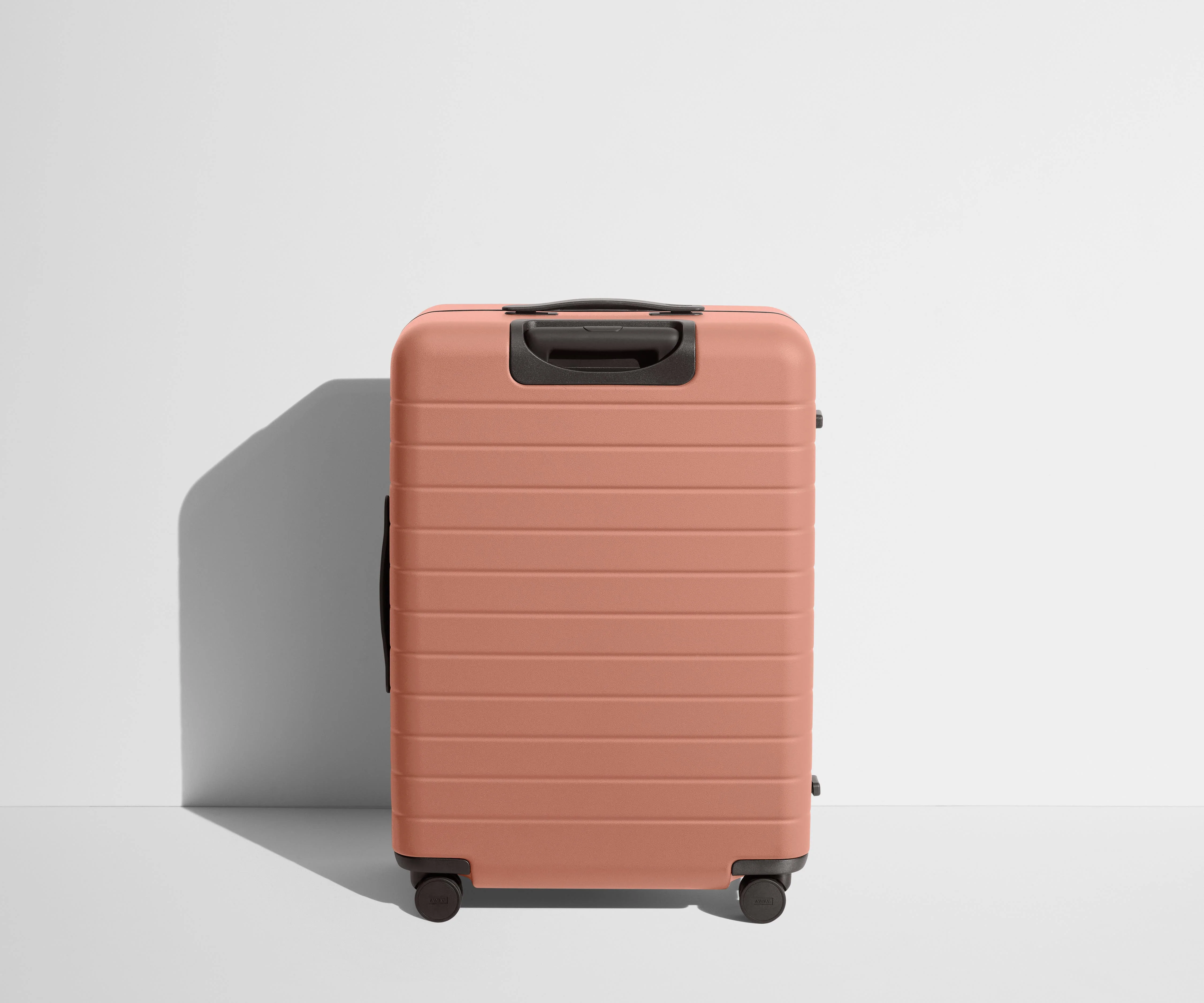 Back product view of The Medium Flex suitcase in Clay Pink