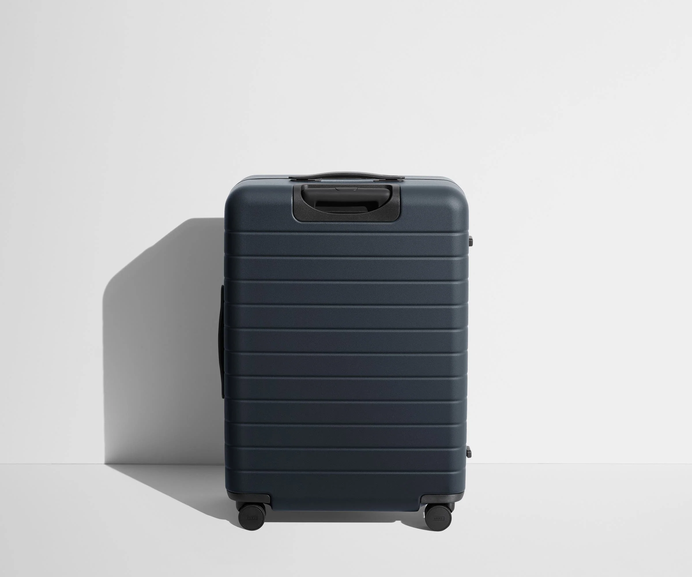 Back product view of The Medium Flex suitcase in Navy Blue