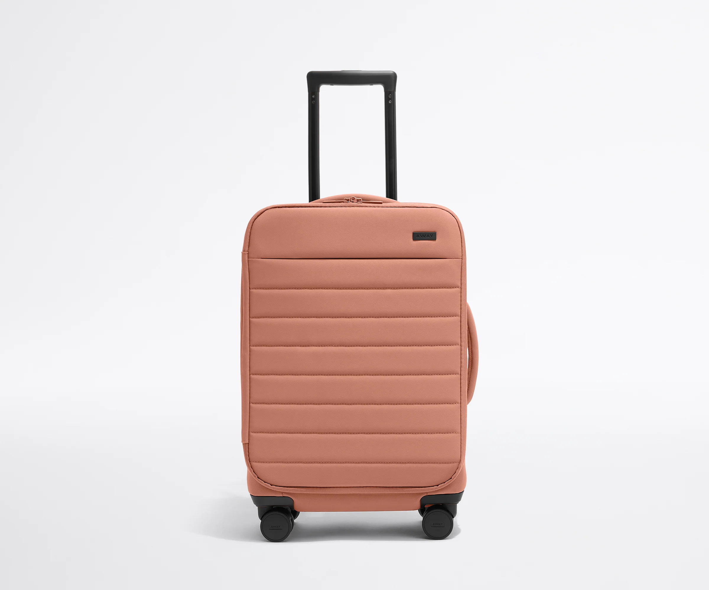 Front product view of The Softside Carry-On suitcase in Clay Pink with raised handle