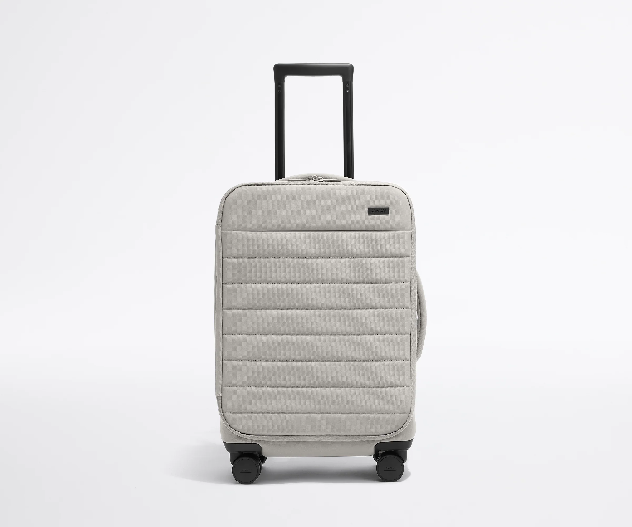Front product view of The Softside Carry-On suitcase in Cloud Gray with raised handle