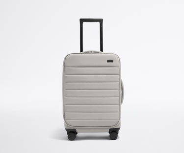Front product view of The Softside Carry-On suitcase in Cloud Gray with raised handle