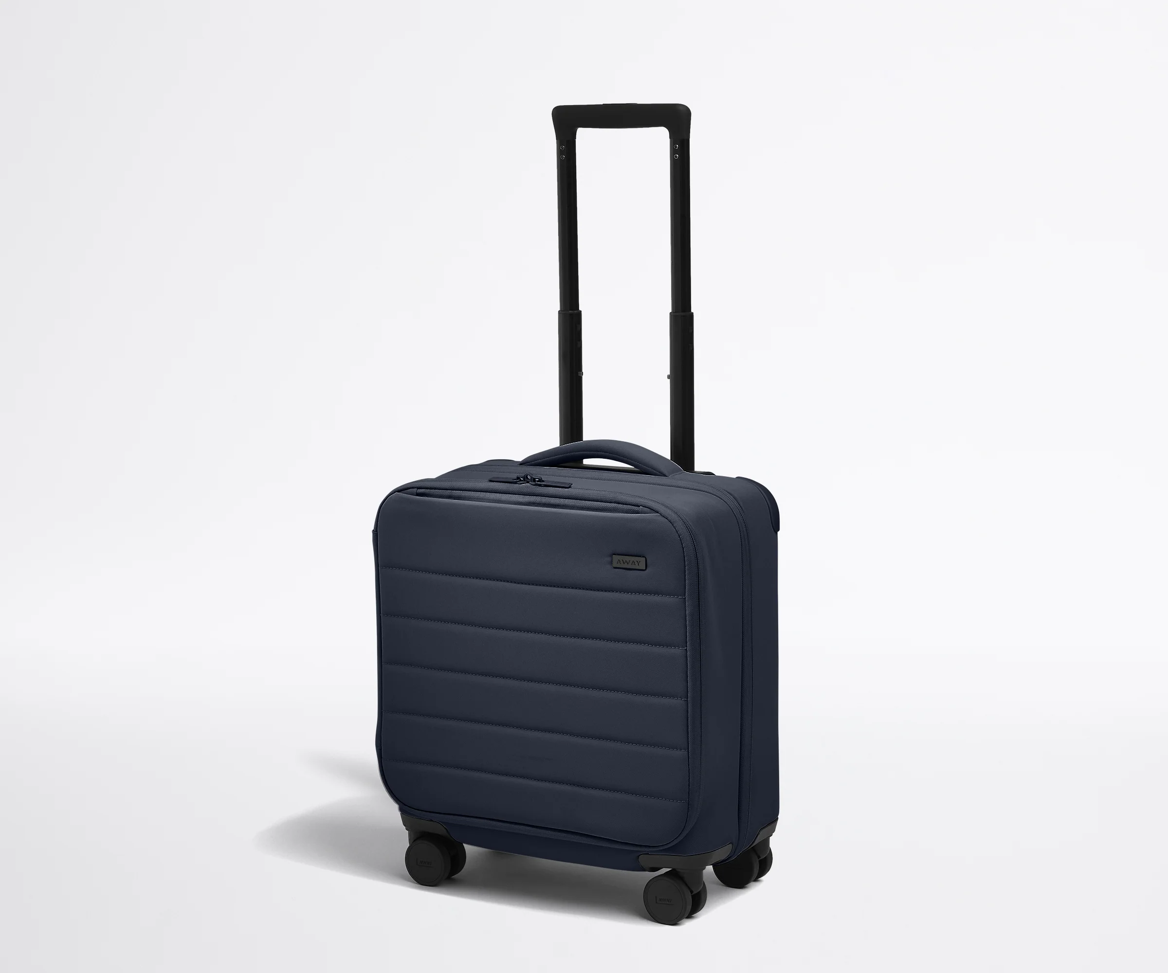 Angled product view of The Softside Compact Carry-On suitcase in Navy Blue with raised handle