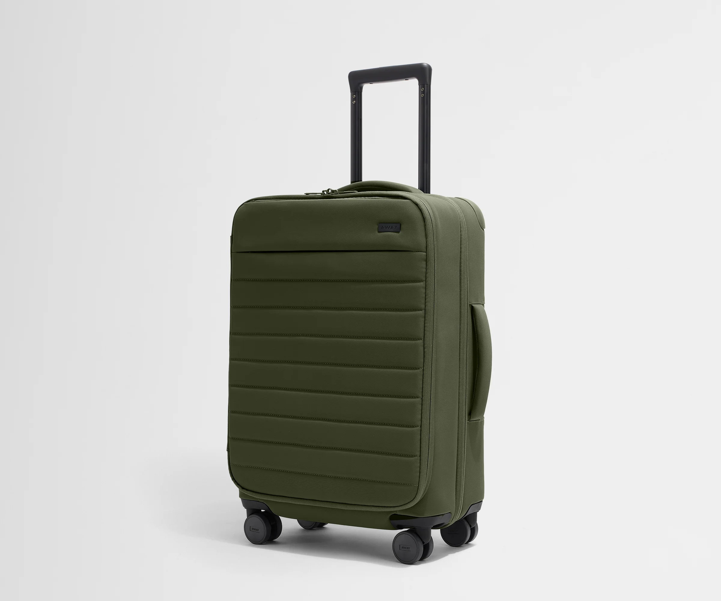 Angled product view of The Softside Bigger Carry-On suitcase in Olive Green with raised handle