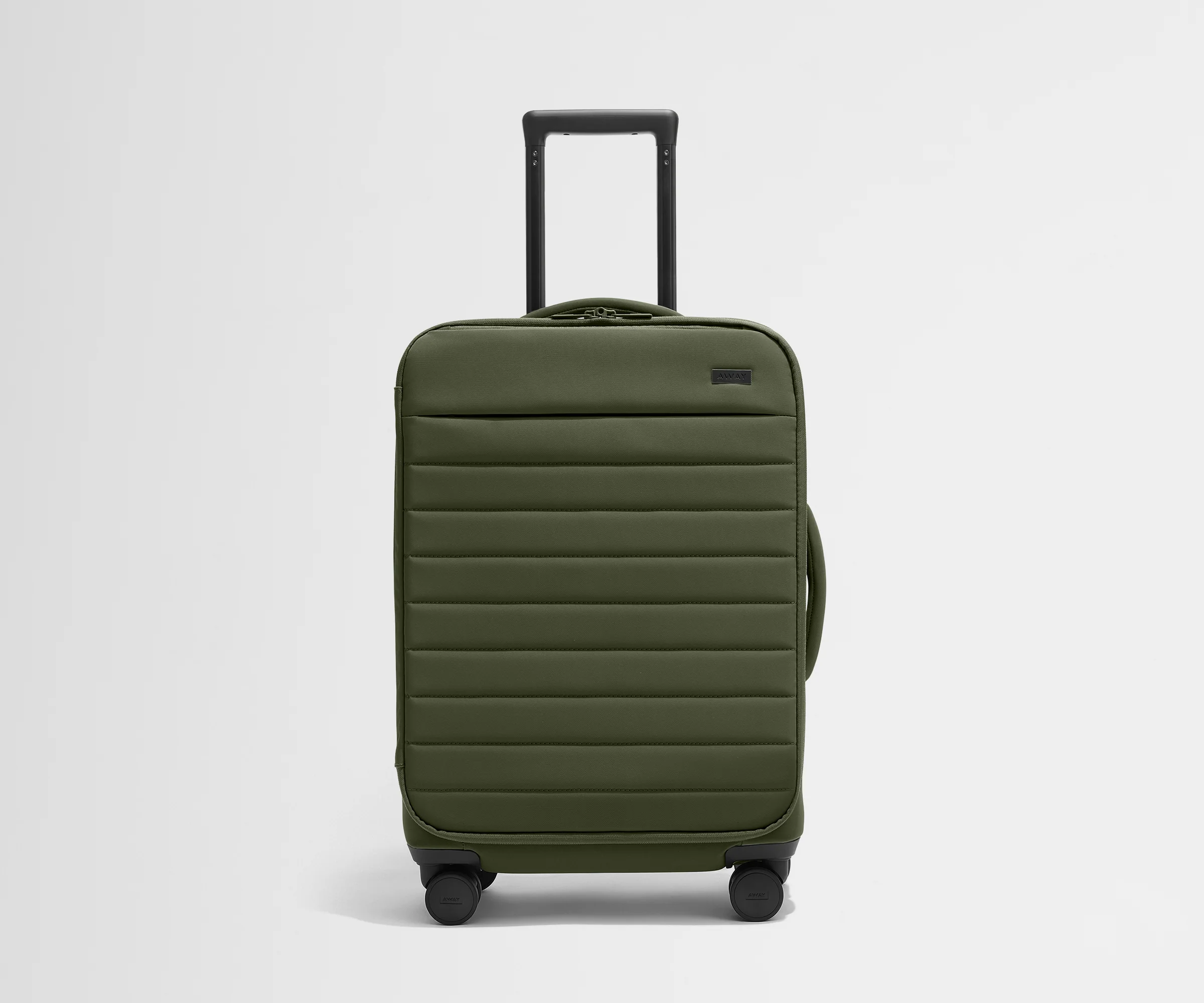 Front product view of The Softside Bigger Carry-On suitcase in Olive Green with raised handle