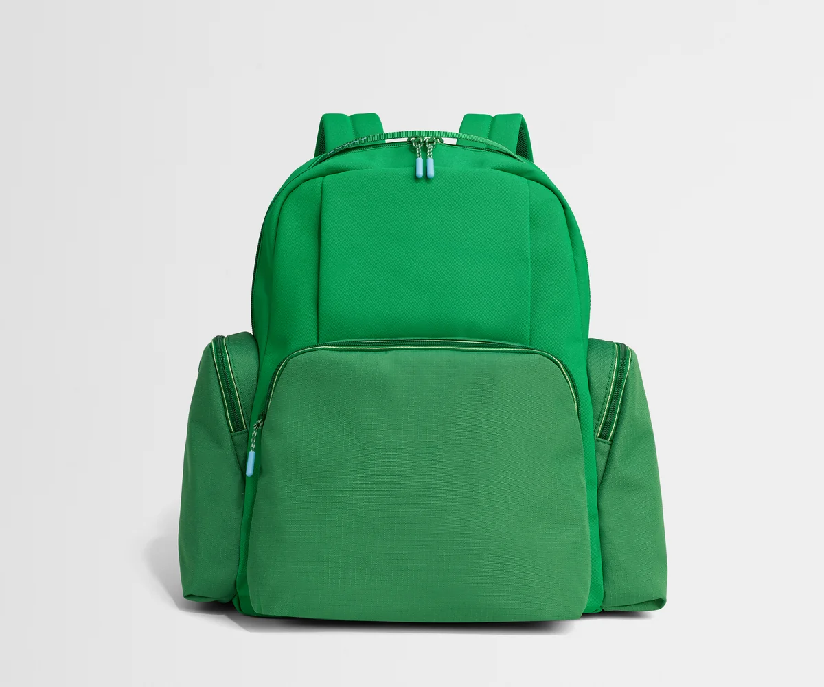 Green backpack on a light gray background