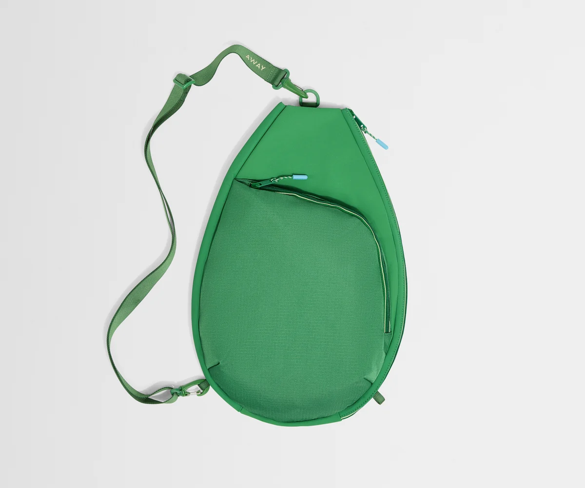Green crossbody bag on a light gray background