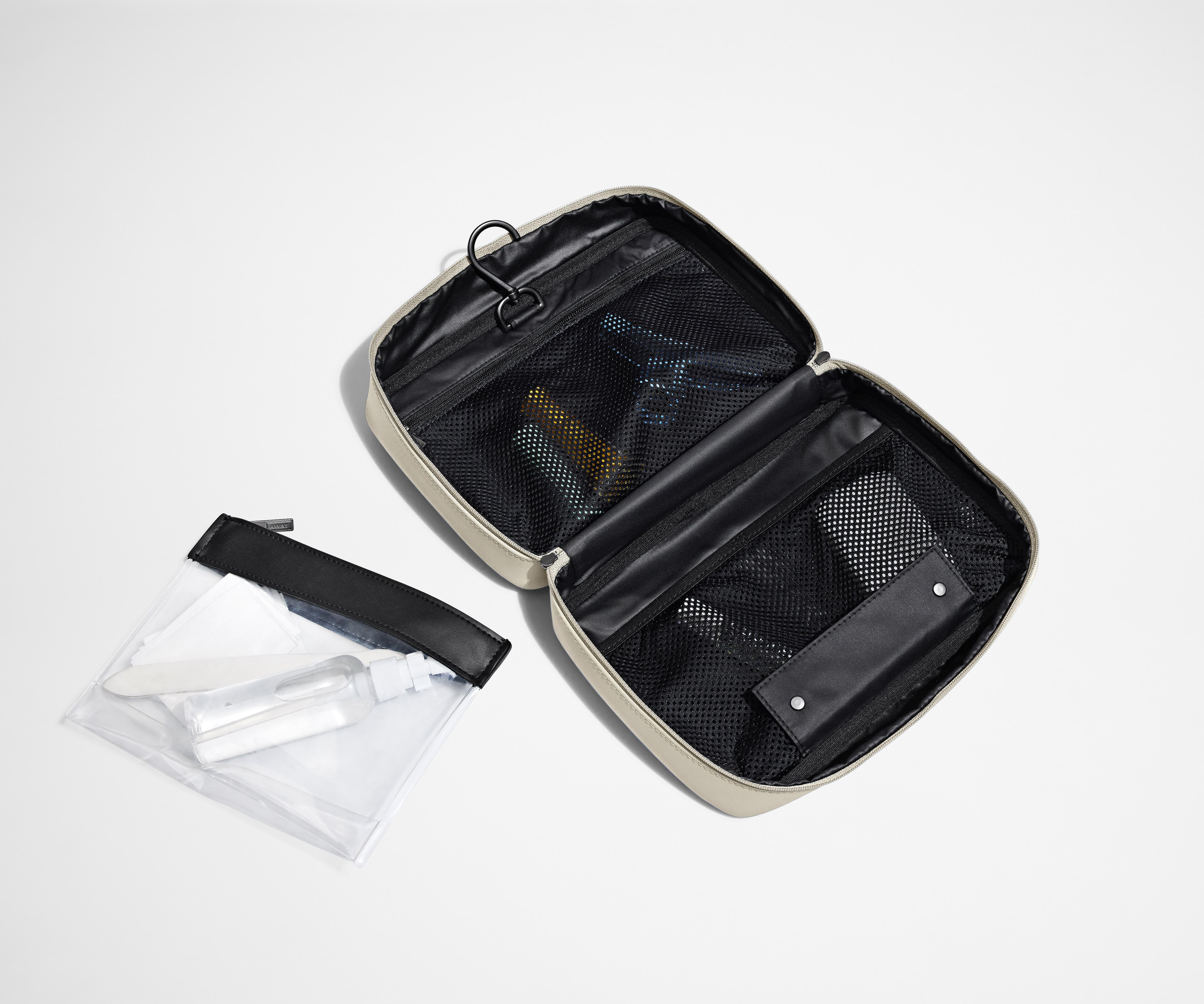 Hanging Toiletry Bag laying flat next to the detachable pouch