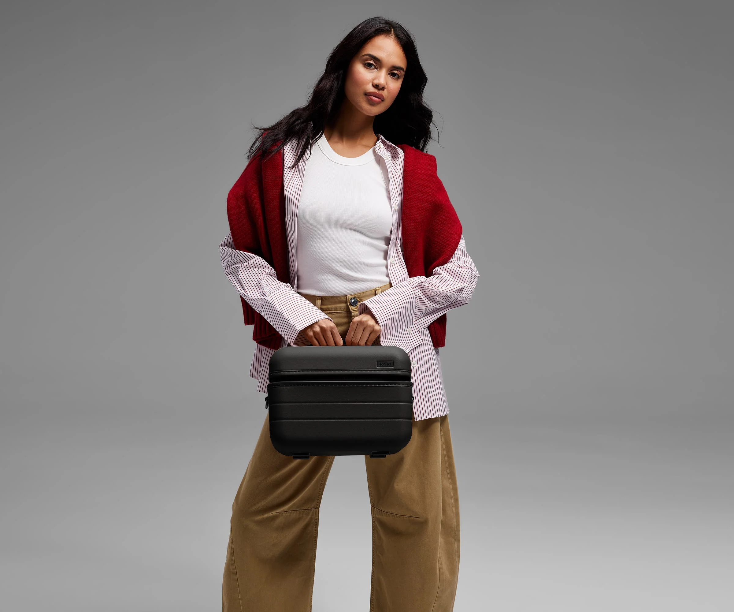 Person carrying the Train Case by its top handle