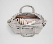 Back main compartment packed with adult travel essentials, including a laptop, notebook, and extra clothes