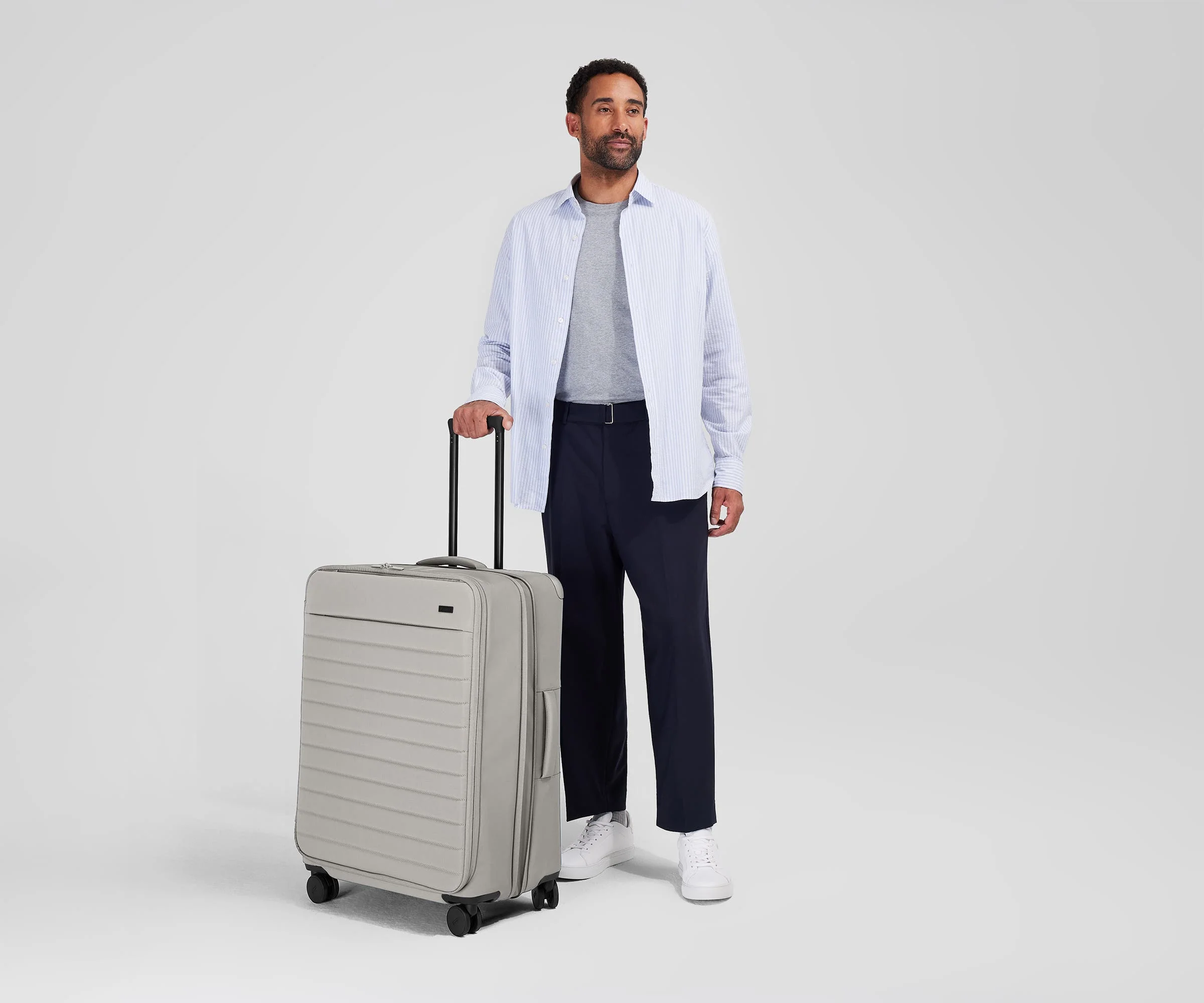 Person standing next to the Softside Large for scale