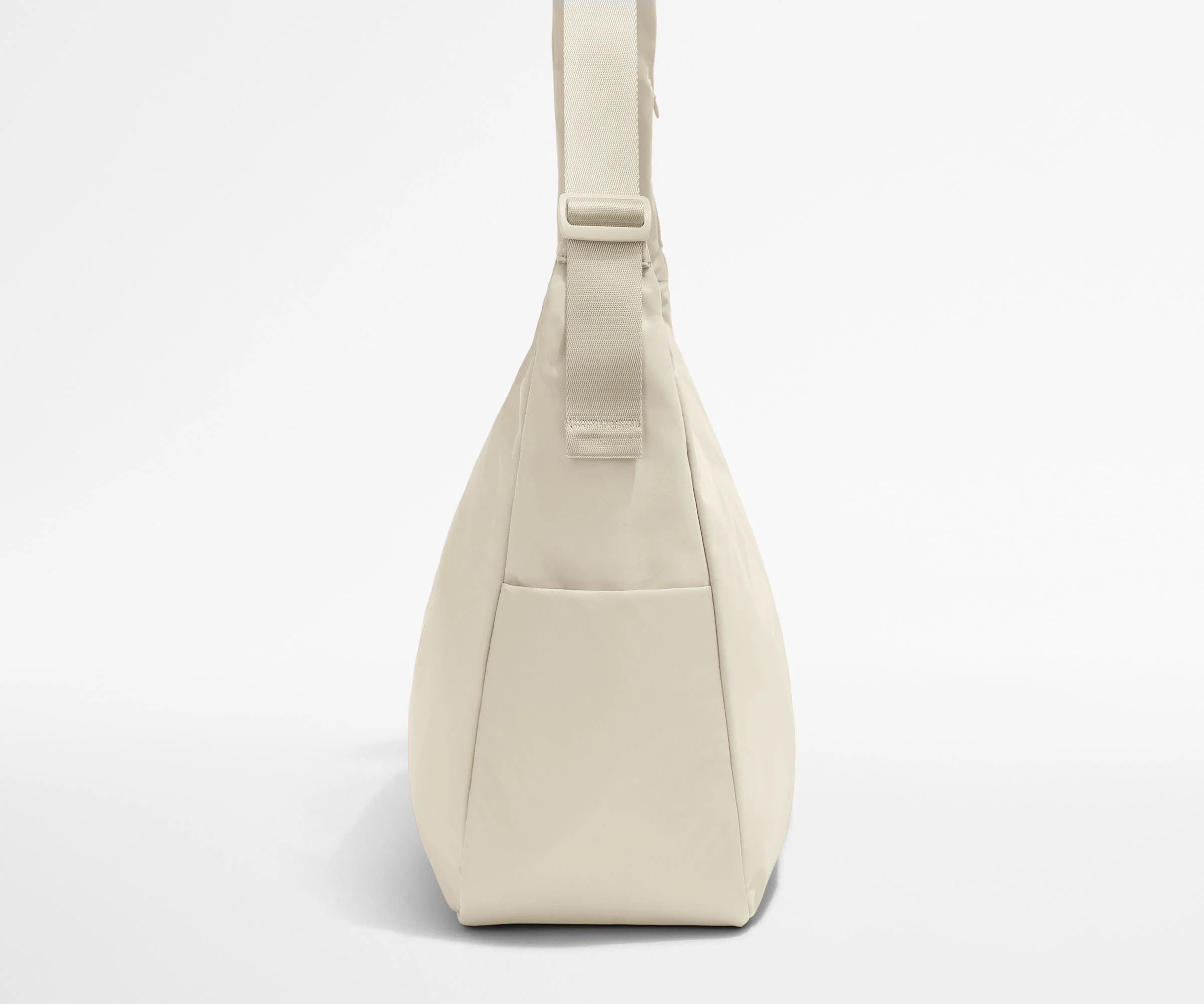 Side view of the Large Featherlight Crossbody showing the exterior bottle pocket