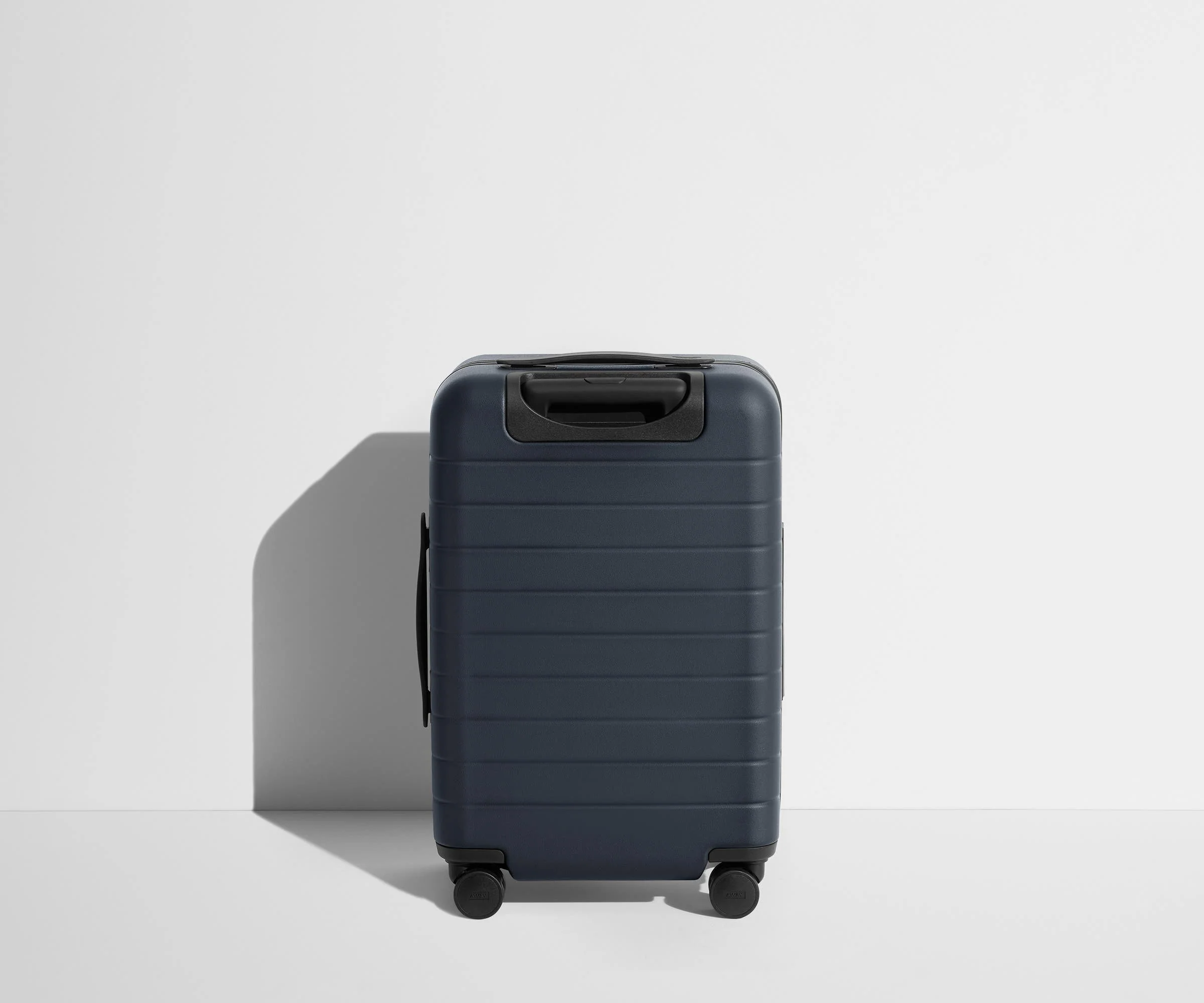 Back product view of The Carry-On suitcase in Navy Blue