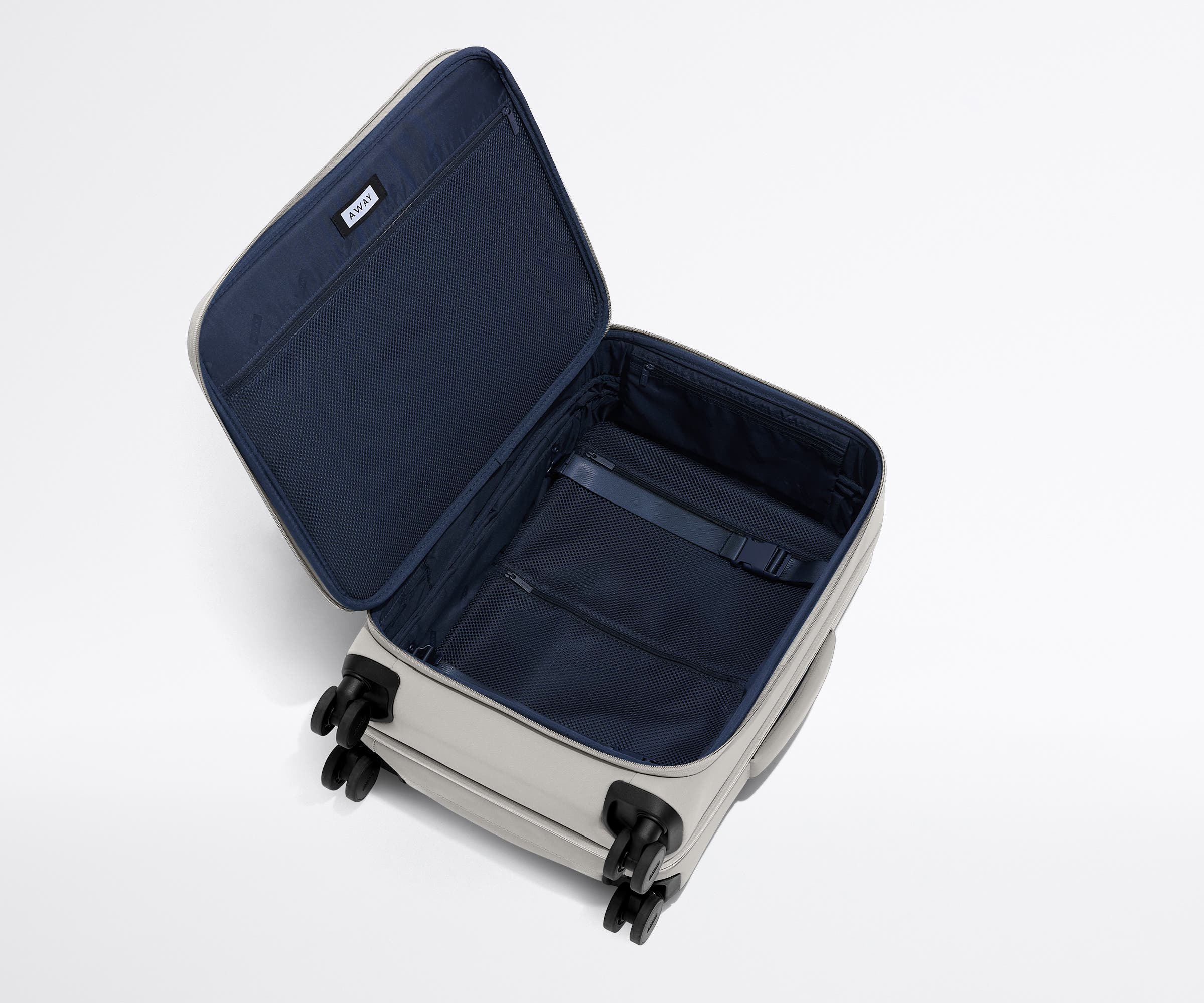 Open, unpacked Softside Bigger Carry-On, showing the depth of the bag and signature compression pad feature