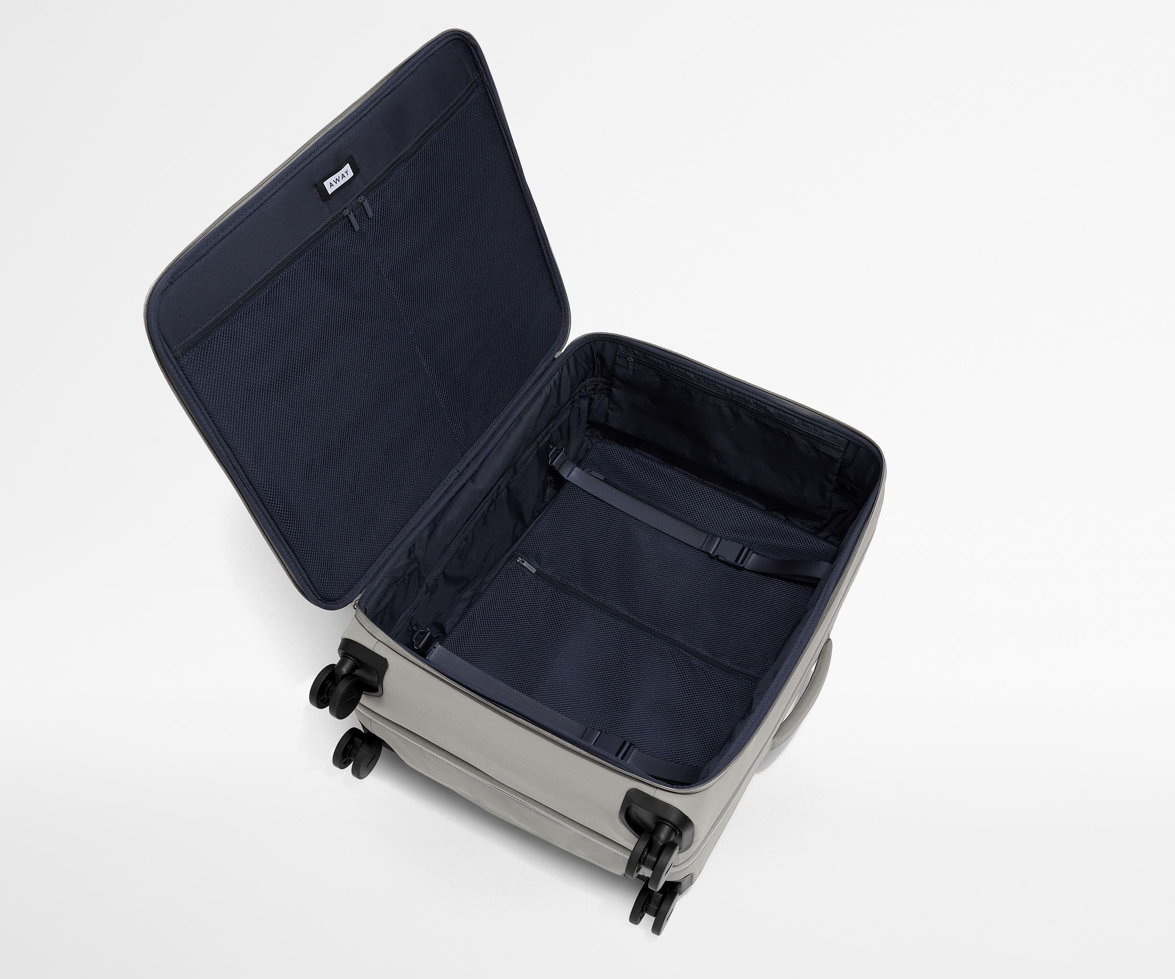Open, unpacked Softside Large suitcase, showing the depth of the bag and signature compression pad feature